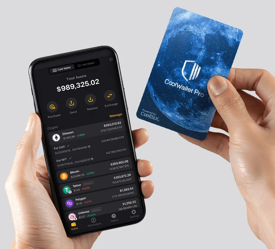 Manufacturer photograph of a CoolWallet Pro card held beside a phone. The app shows Cold Wallet and Hot Wallet tabs.
