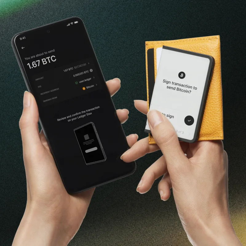 Phone beside a Ledger Stax held in a yellow case, with Stax showing the final Bitcoin signing prompt.