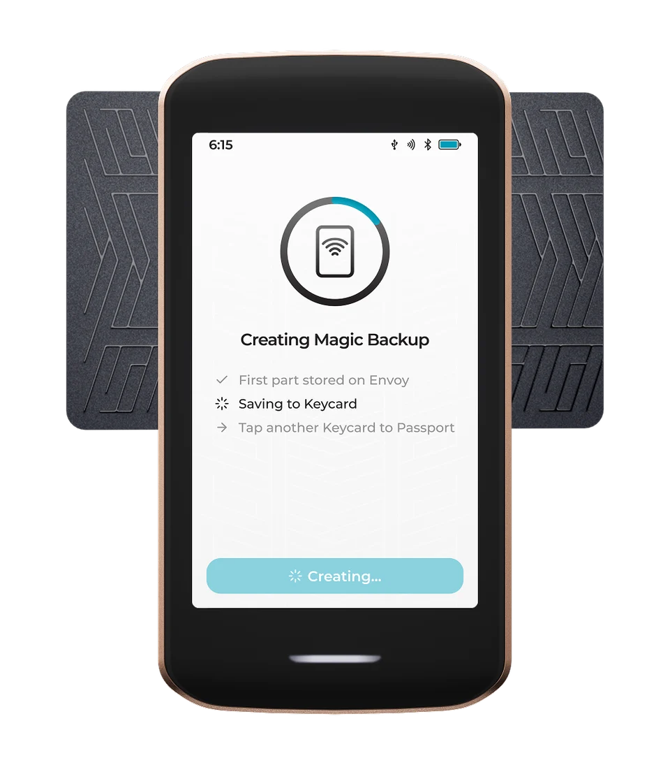 Manufacturer illustration of Passport Prime with a Keycard held horizontally behind the upper part of the device, forming a T shape. The screen shows Creating Magic Backup.