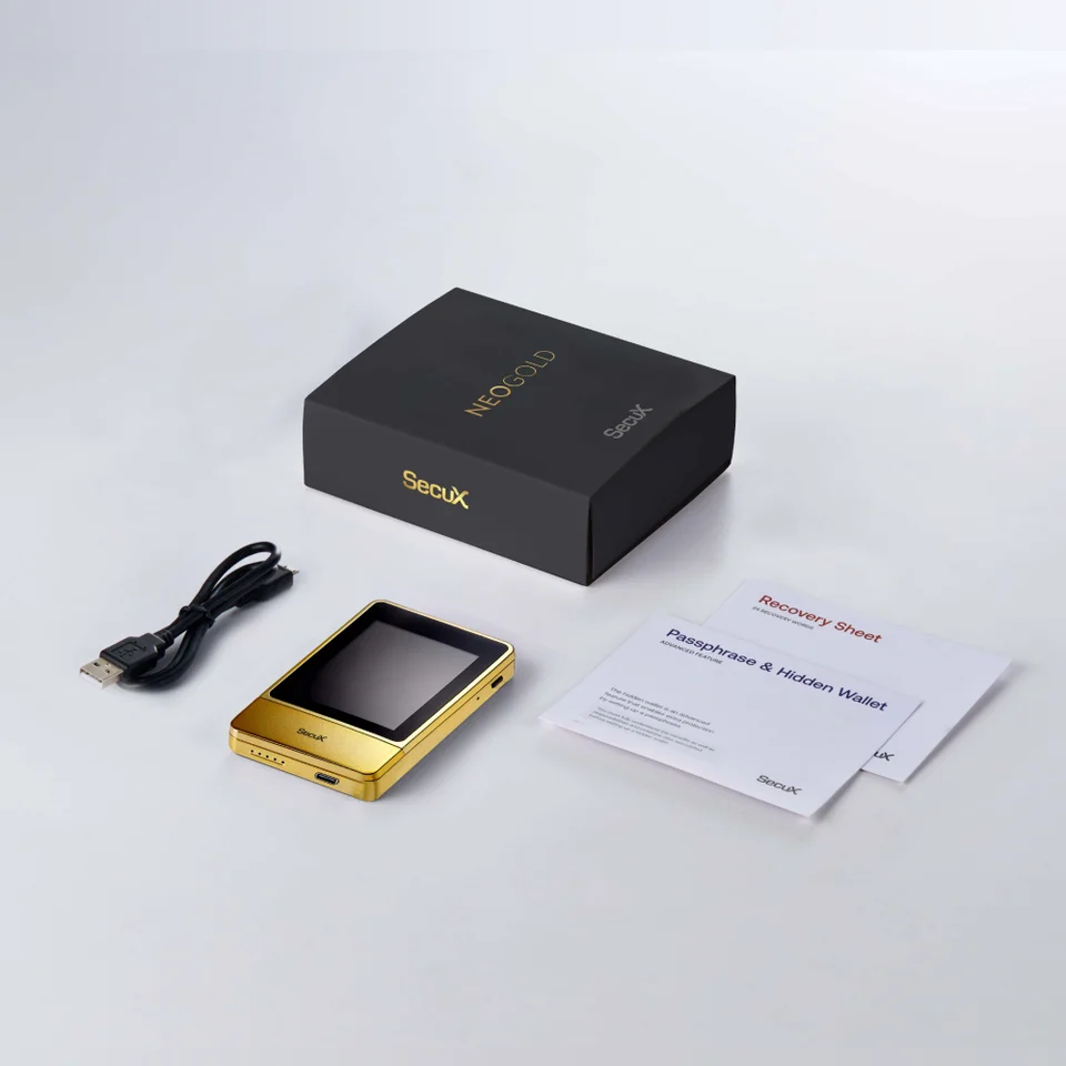 SecuX NeoGold beside blank paper recovery materials, a USB cable and its box.