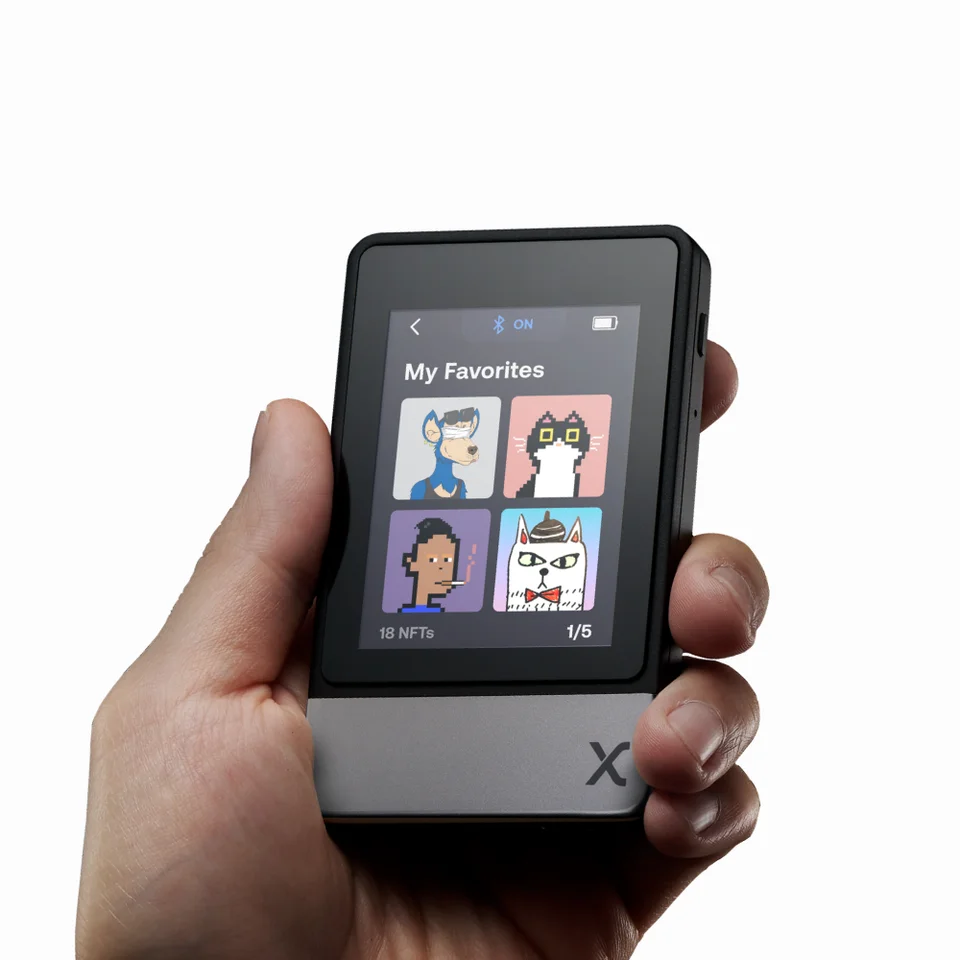 Una mano sostiene SecuX Neo-X con imágenes NFT en la galería My Favorites de su pantalla táctil.