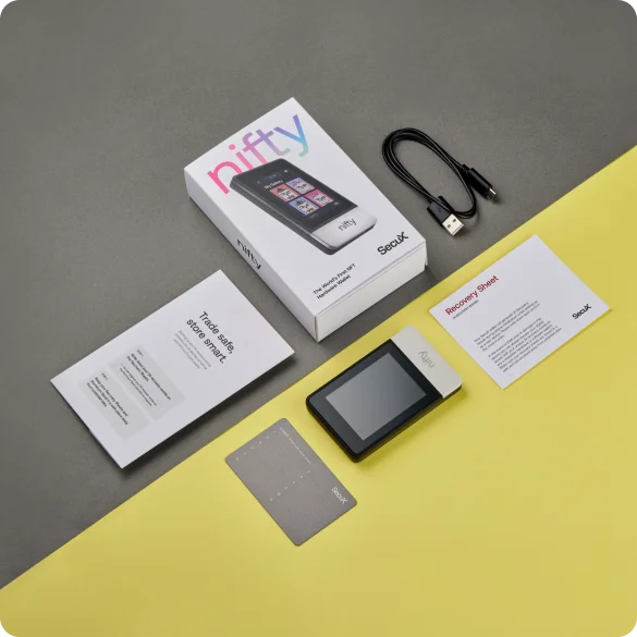 SecuX Nifty beside a blank metal backup sheet, paper materials, a USB cable and its box.