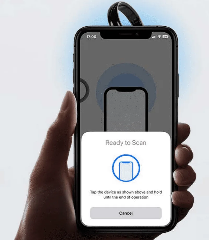 Tangem’s setup illustration shows a ring removed from the finger at the top of an iPhone, with Ready to Scan on the screen.