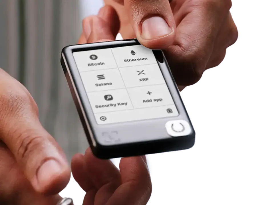 Hands holding Ledger Nano Gen5 with app icons visible on its screen.